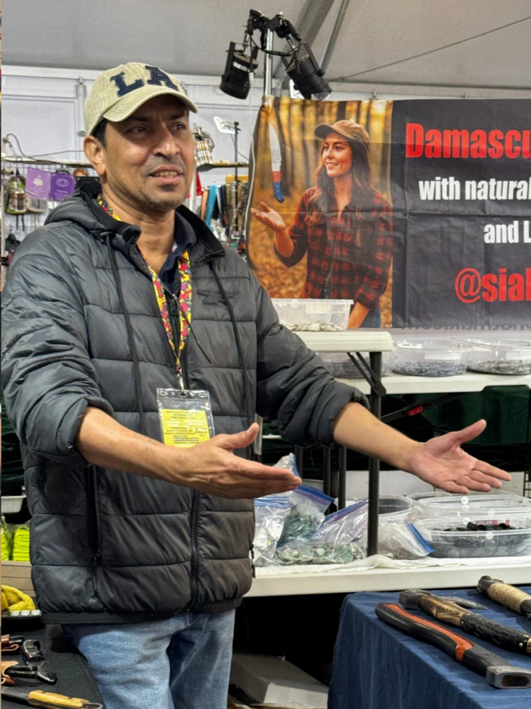 MJ, founder of K2 Belts, standing at the company trade show booth