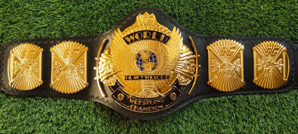 Gold championship belt with eagle designs and a black strap